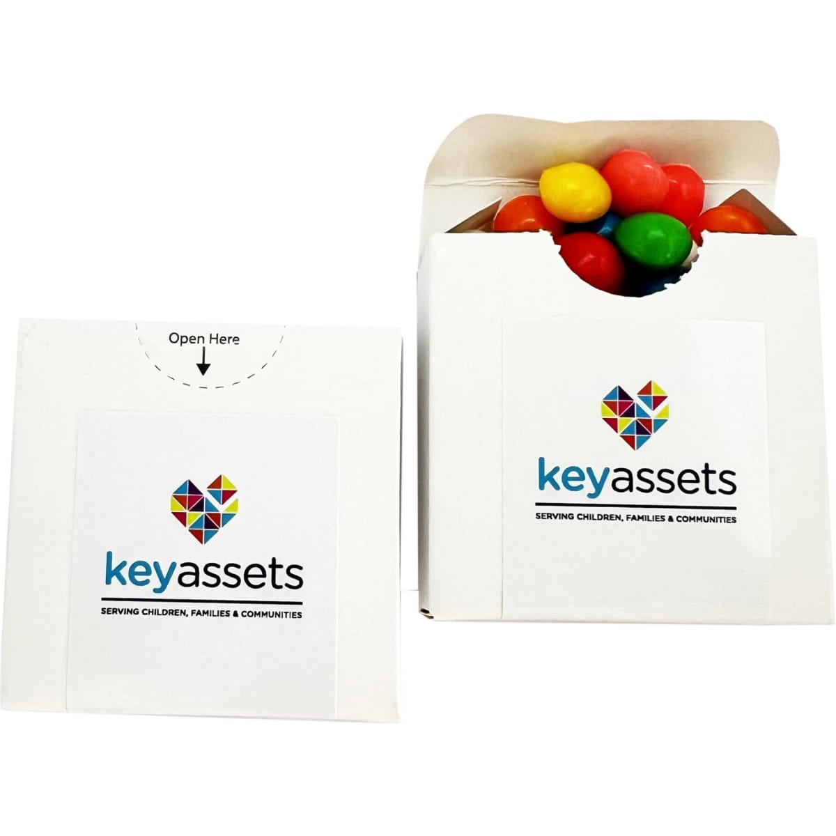 A white flip lid cardboard box containing colourful chewy fruit candies. The box features a logo on the front.