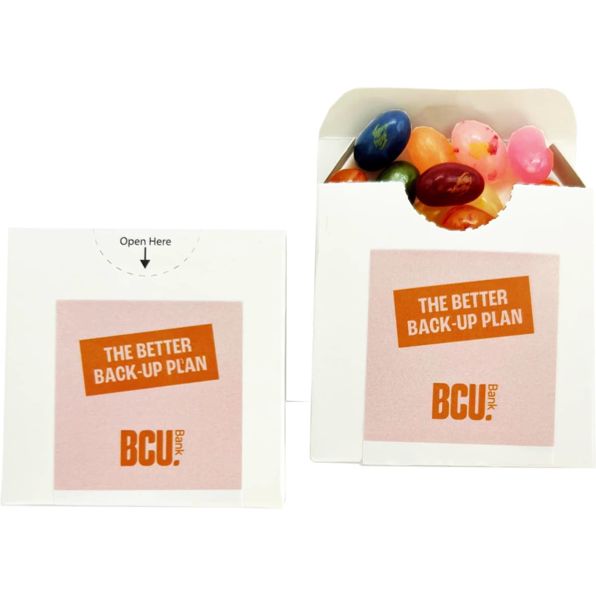 A flip lid cardboard box containing assorted JELLY BELLY jelly beans in various colours. It features a logo.