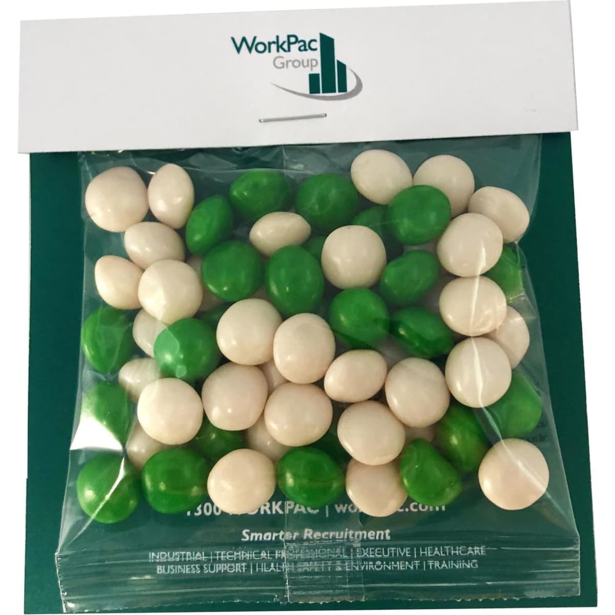 A sealed bag of chewy fruit balls in green and white, featuring a logo on the packaging.