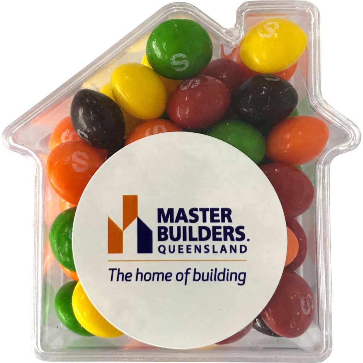 A clear acrylic house-shaped container filled with colourful Skittles in various shades. It features a logo on the front.
