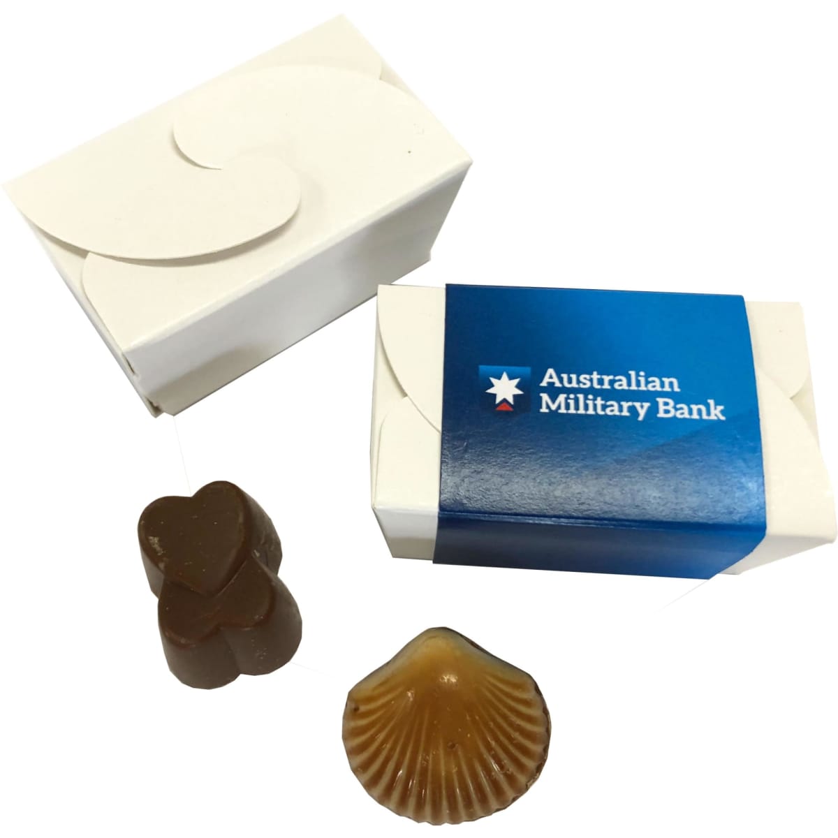 A petite white chocolate box with two assorted chocolates, one heart-shaped and one shell-shaped, featuring a logo.