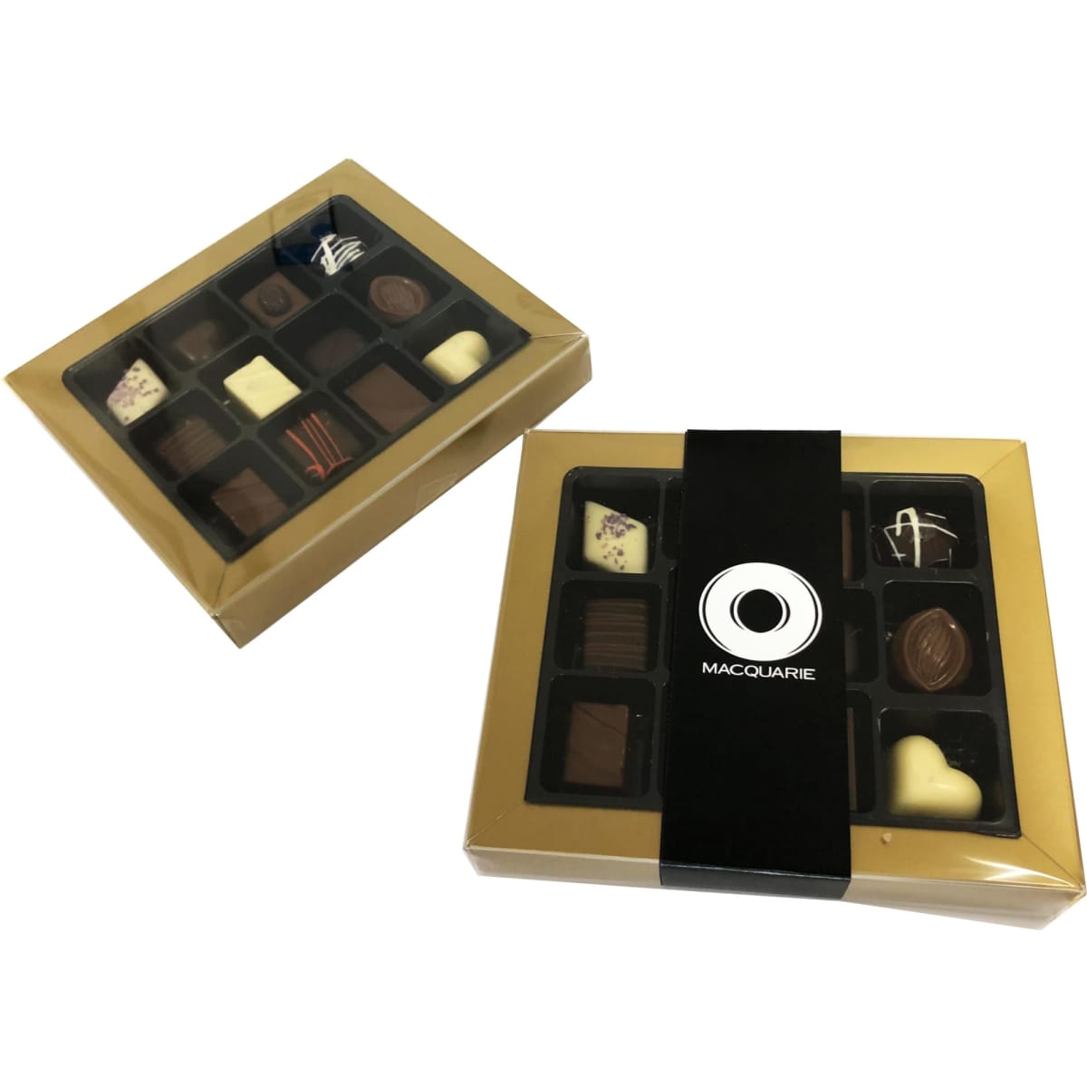 A boxed assortment of chocolates in a gold rimmed package, featuring various chocolate shapes and designs.
