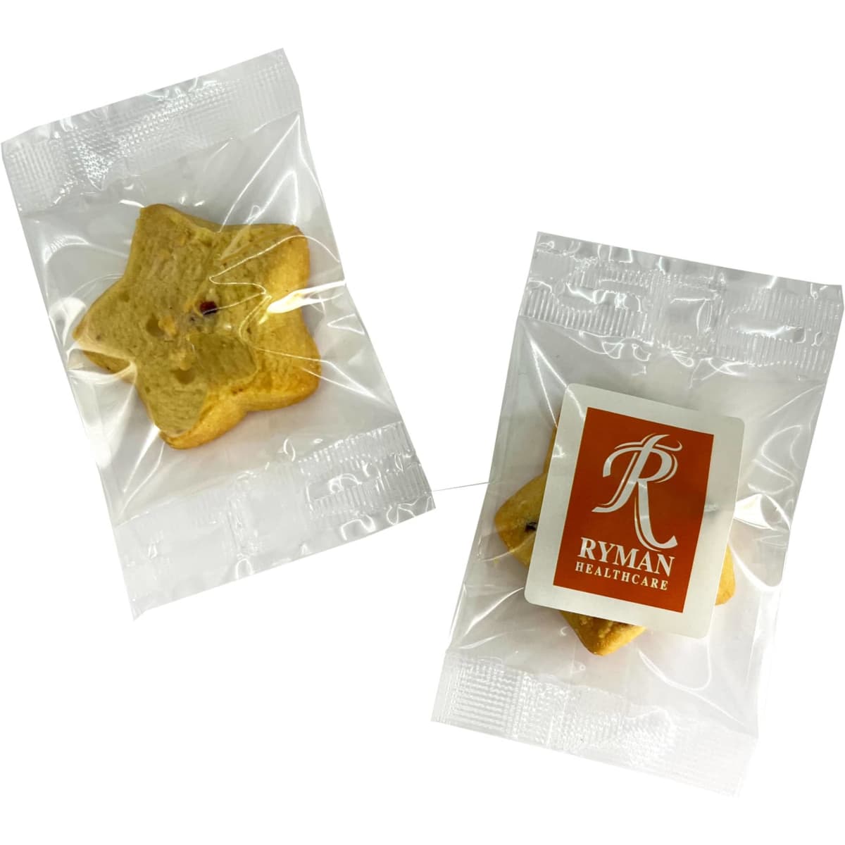Two individually wrapped shortbread star biscuits in light yellow, featuring a logo on one package.
