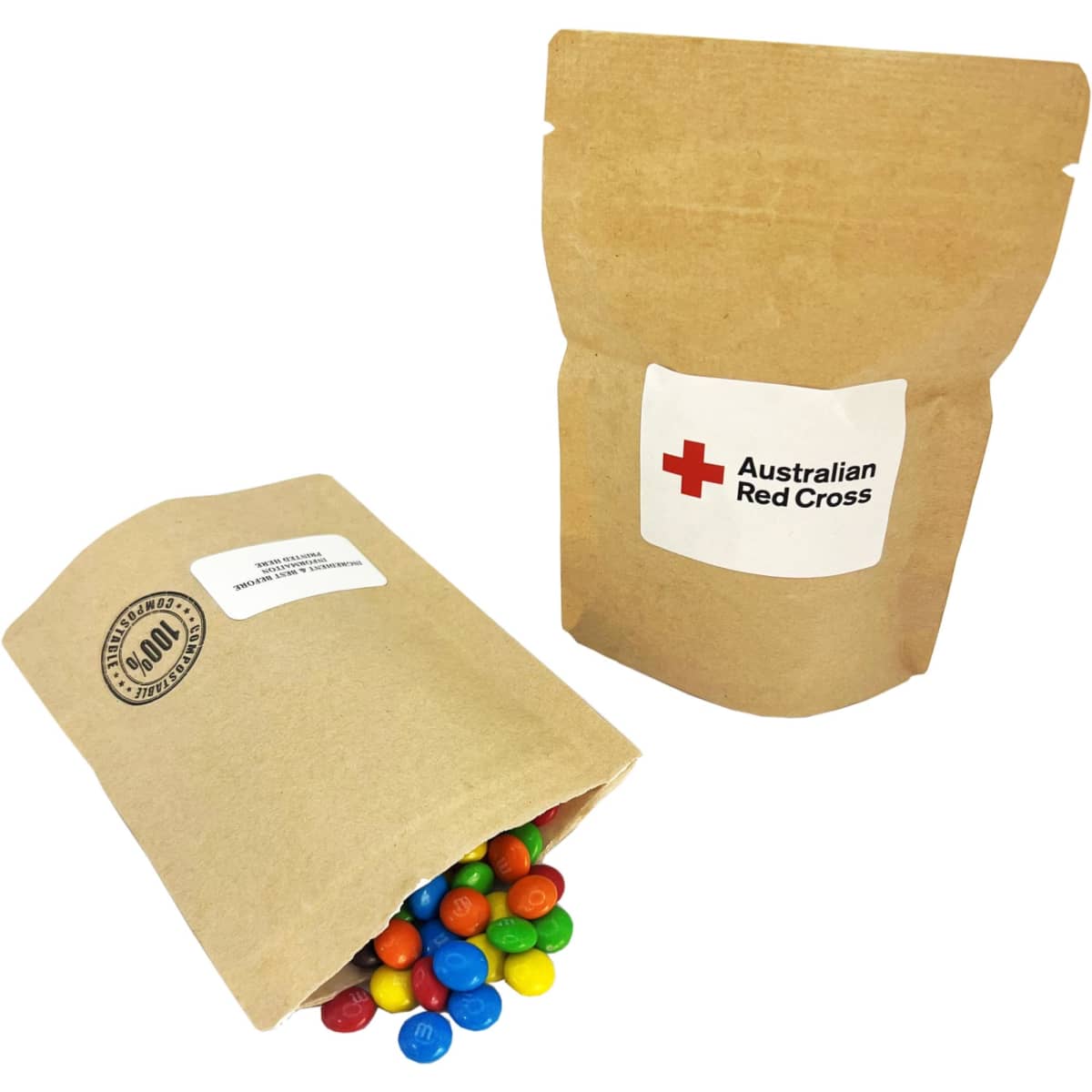 A compostable bag containing colourful M&Ms spilling out, with a simple natural kraft design and a logo.