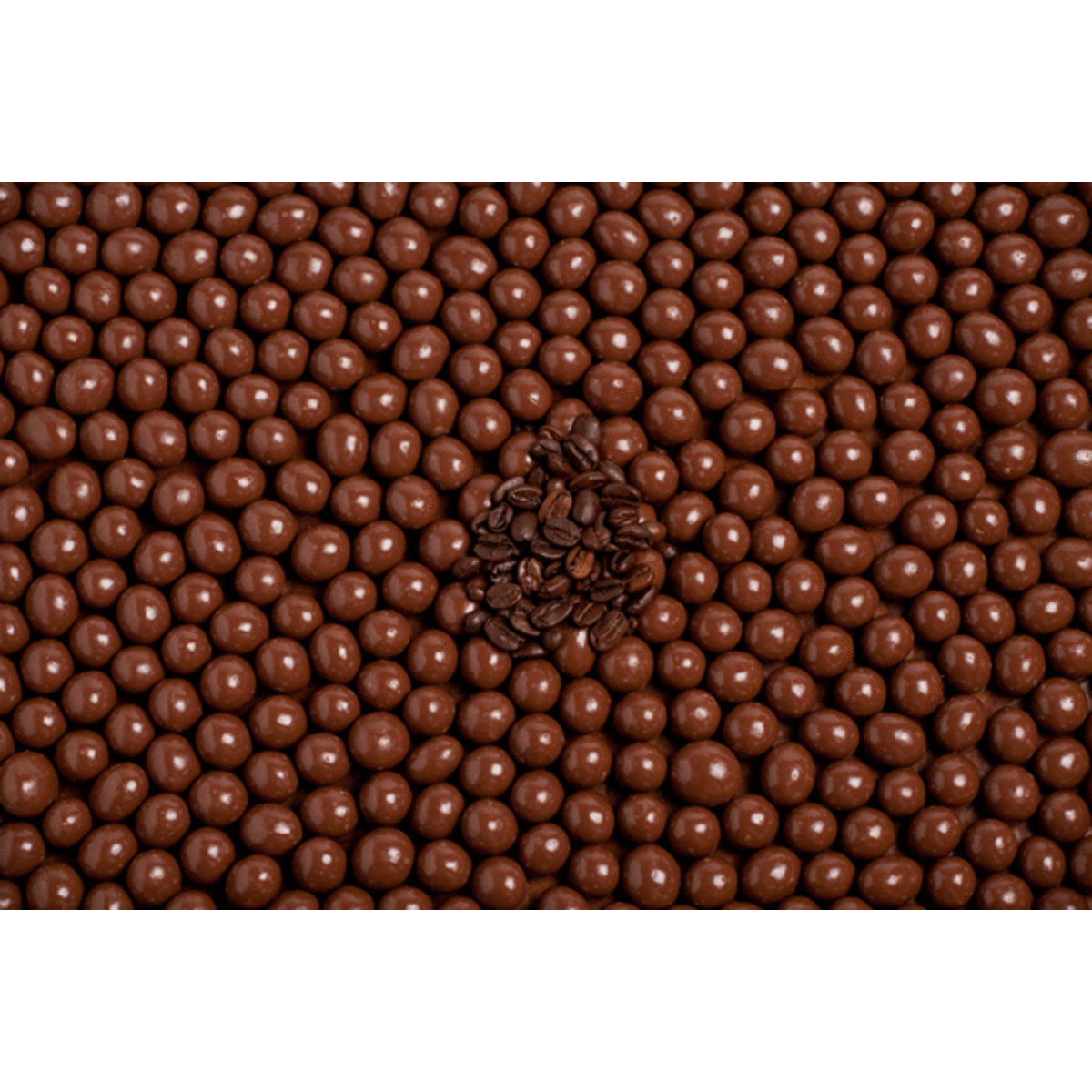 Milk chocolate-coated coffee beans arranged in a cluster, surrounded by a multitude of similar chocolate-covered beans.