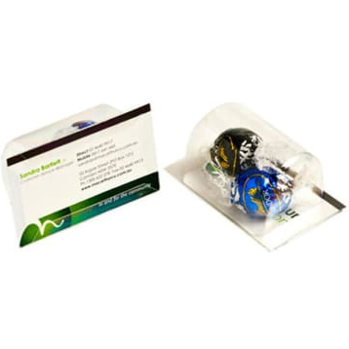 A business card holder featuring two Lindt chocolate balls, one black and one blue, in a clear packaging.