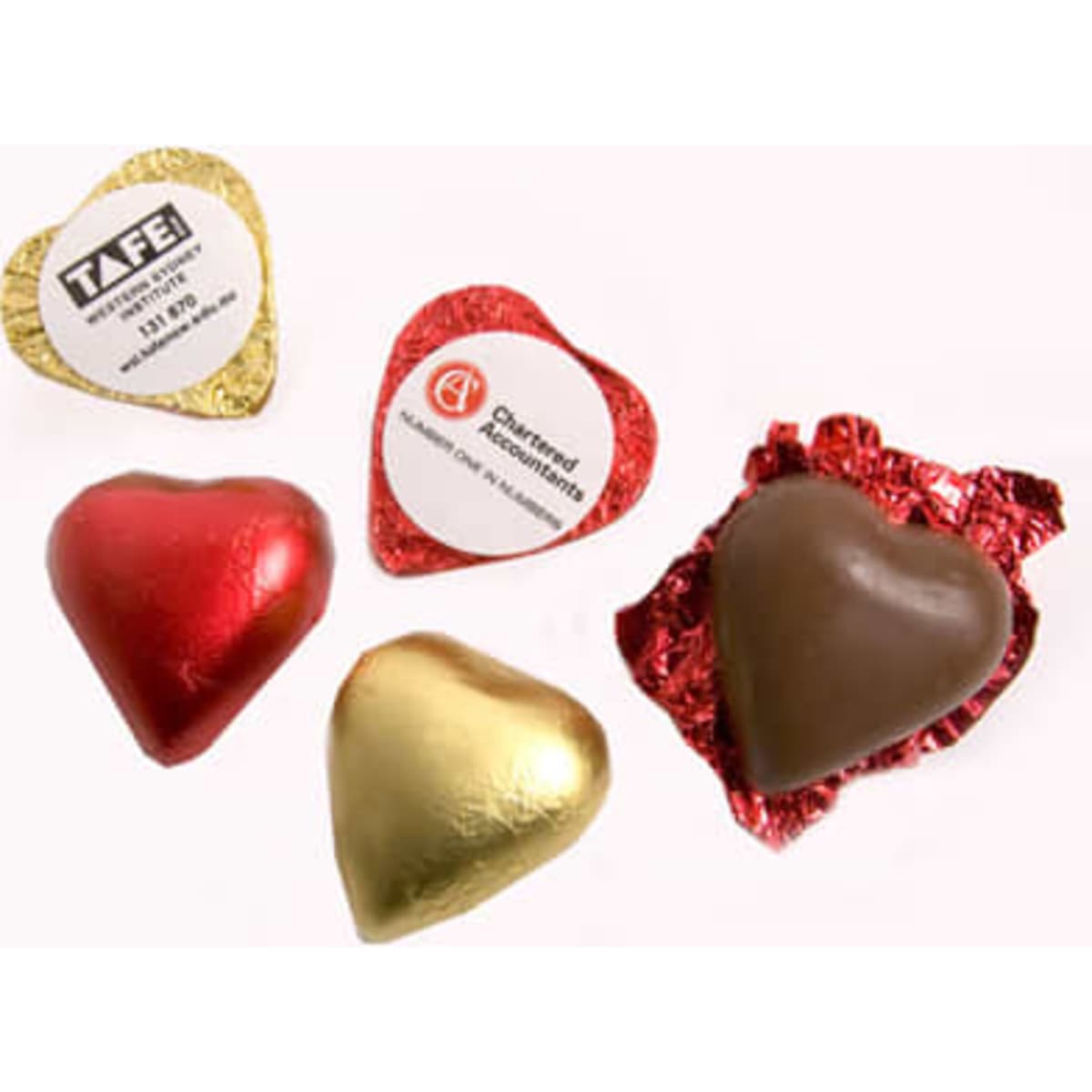 A selection of chocolate hearts in red, gold, and brown foil, featuring various shapes and wrapping.
