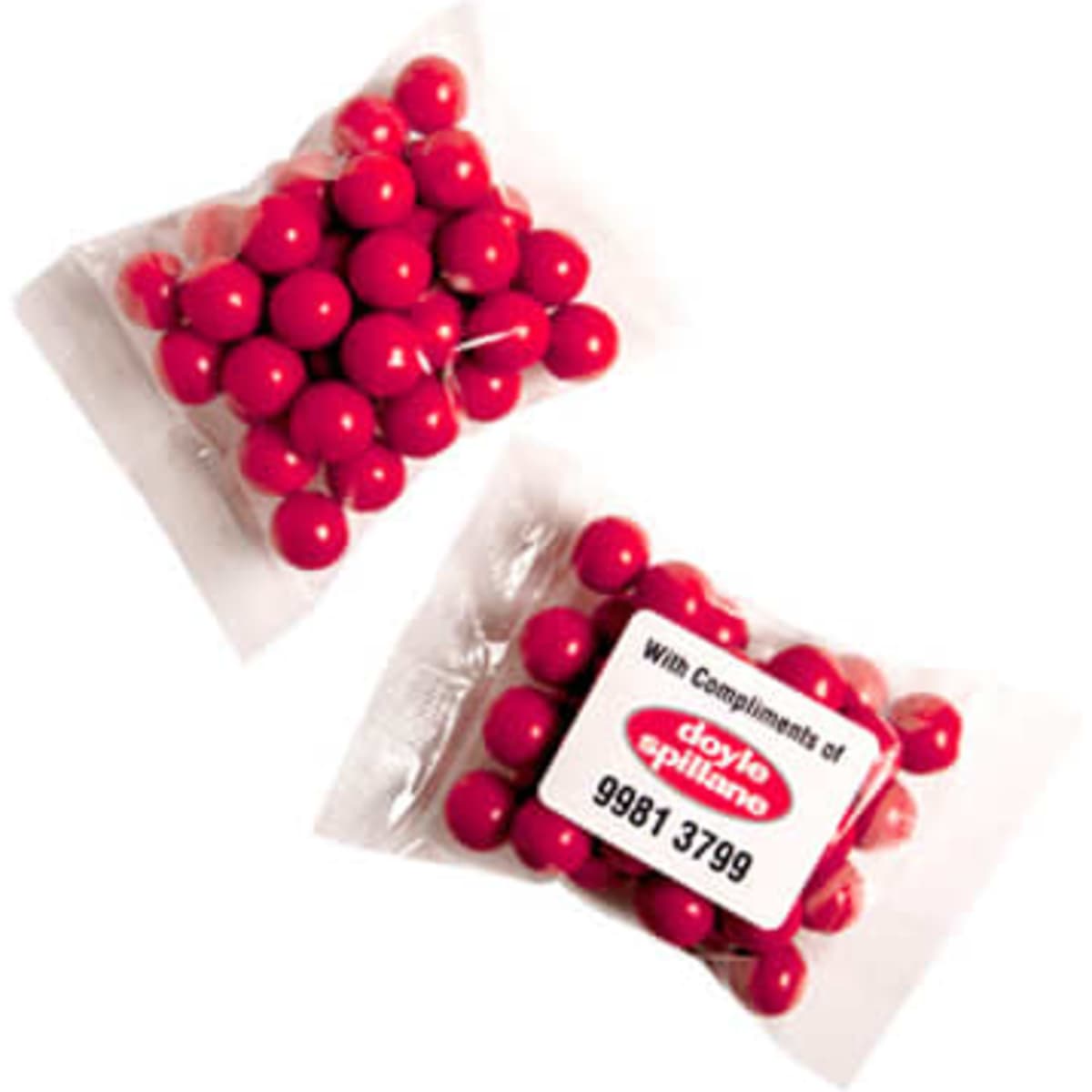 A transparent bag containing round, orange chocolate drops, resembling Jaffa lollies.
