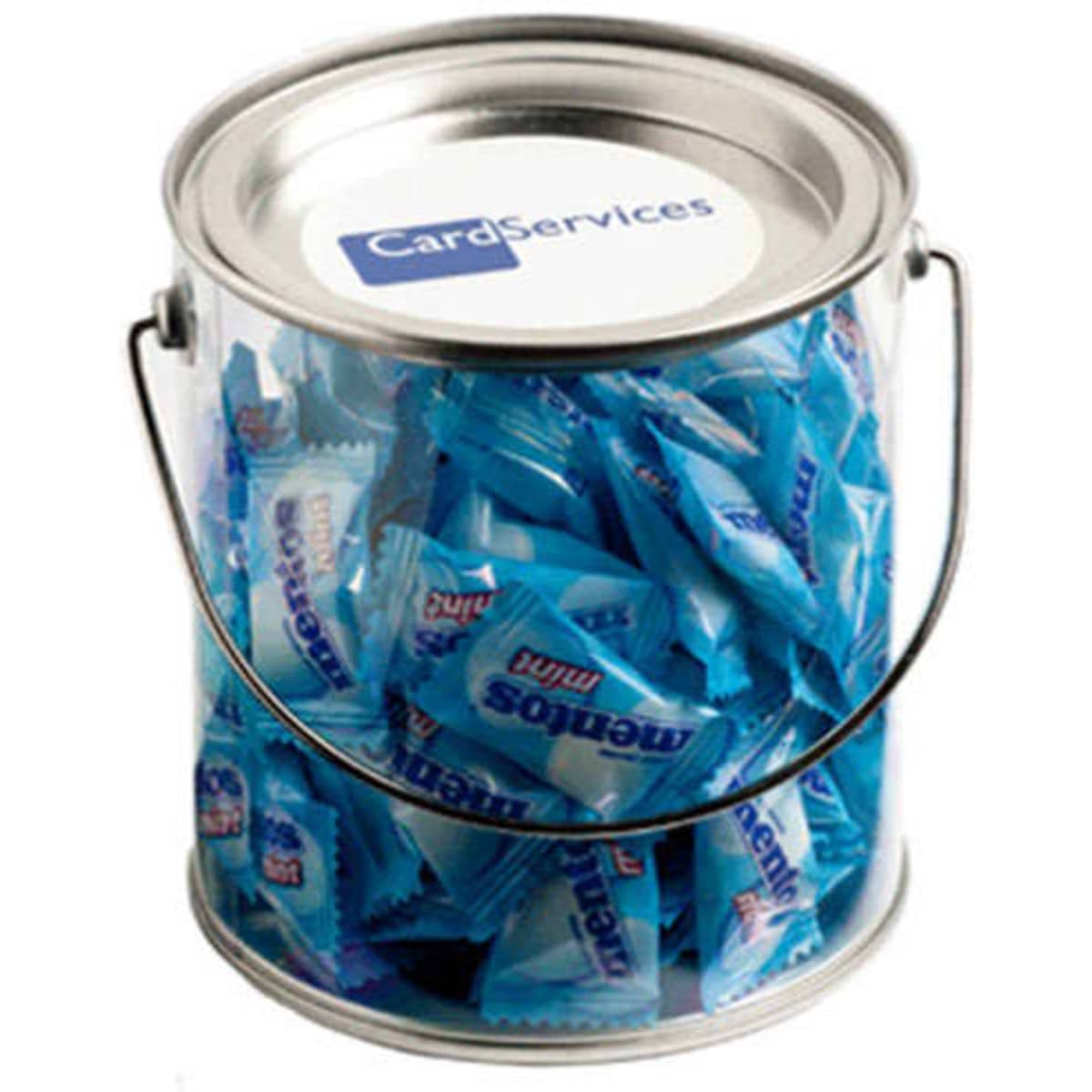 A clear PVC bucket filled with blue-wrapped Mentos mints. The bucket has a metal handle and a logo on top.