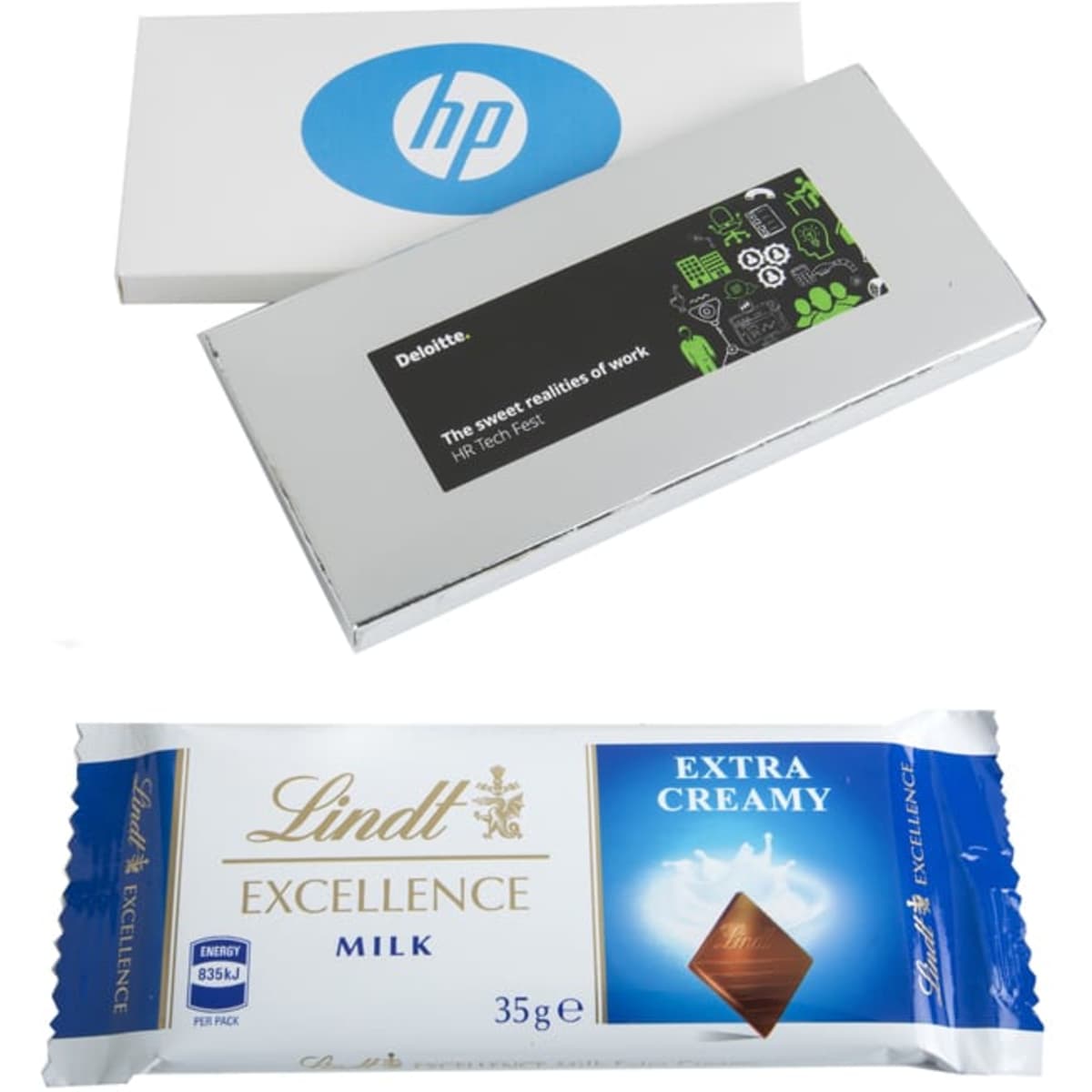 A silver box containing a 35g Lindt chocolate bar, labelled as Extra Creamy Milk, alongside a white box with a logo.