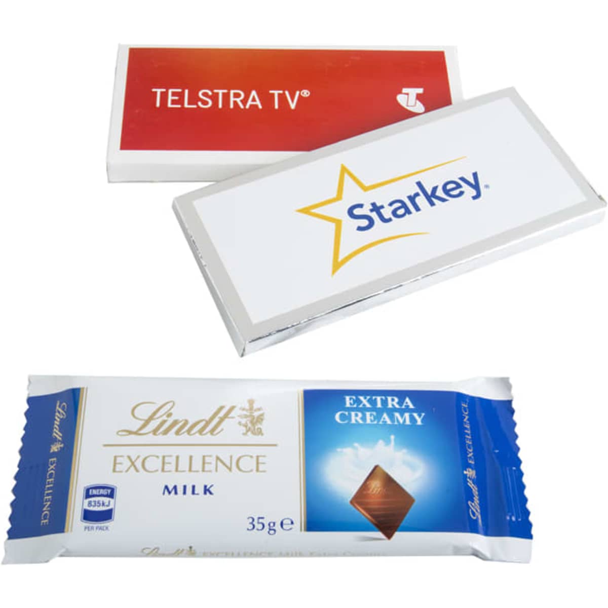 A milk chocolate bar with white and silver packaging, featuring a logo and a bigger sticker design.