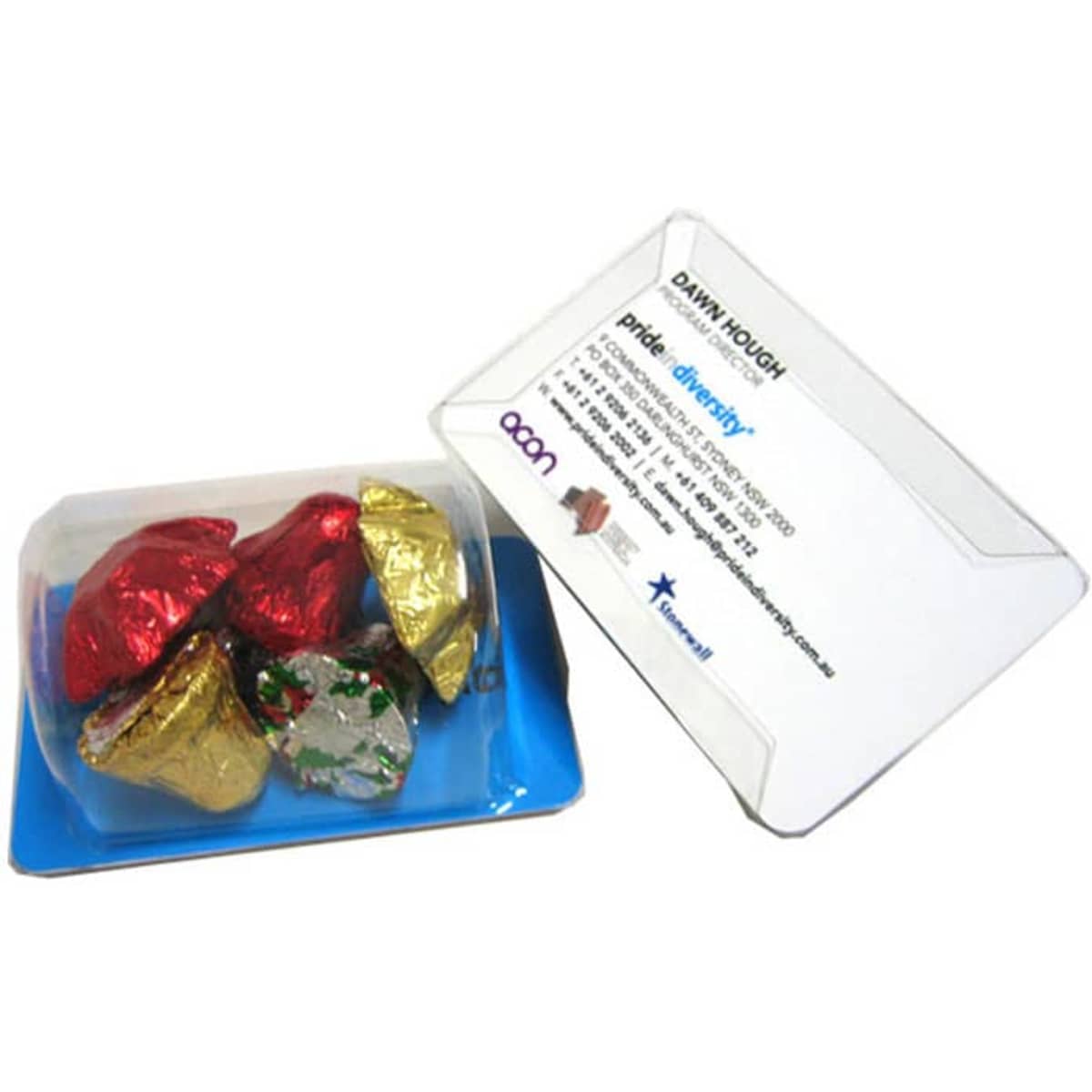A clear business card holder featuring assorted Christmas chocolates wrapped in red, gold, and silver foil.