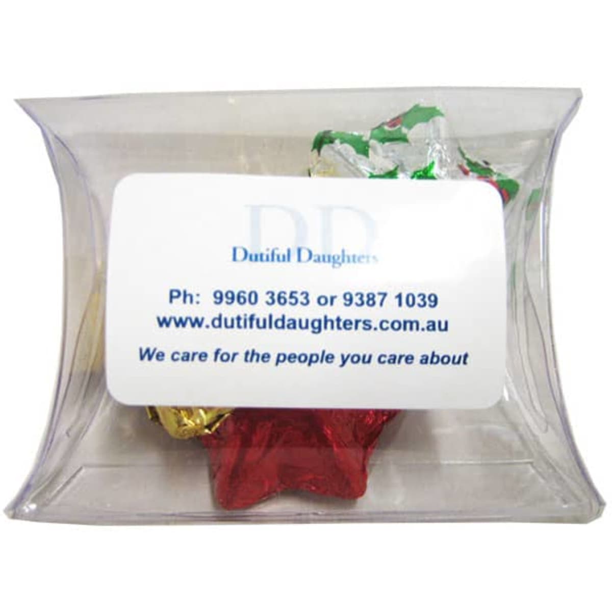 A clear pillow pack containing Christmas-themed chocolates wrapped in red, gold, and silver foil.