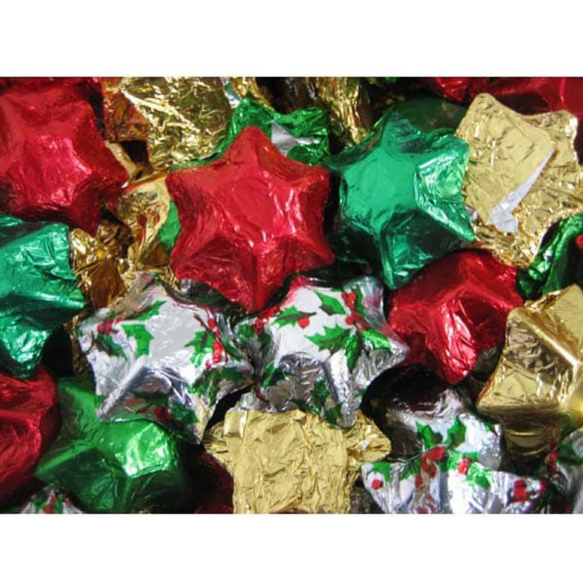 Chocolate stars wrapped in red, green, gold, and silver foil, forming a colourful festive display.