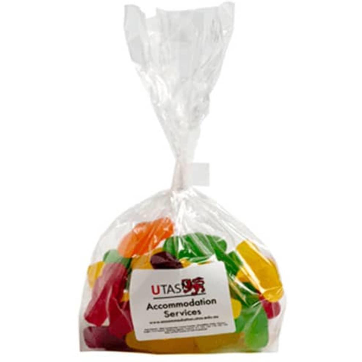 A clear bag filled with mixed lollies in various colours, sealed at the top. The bag features a logo.