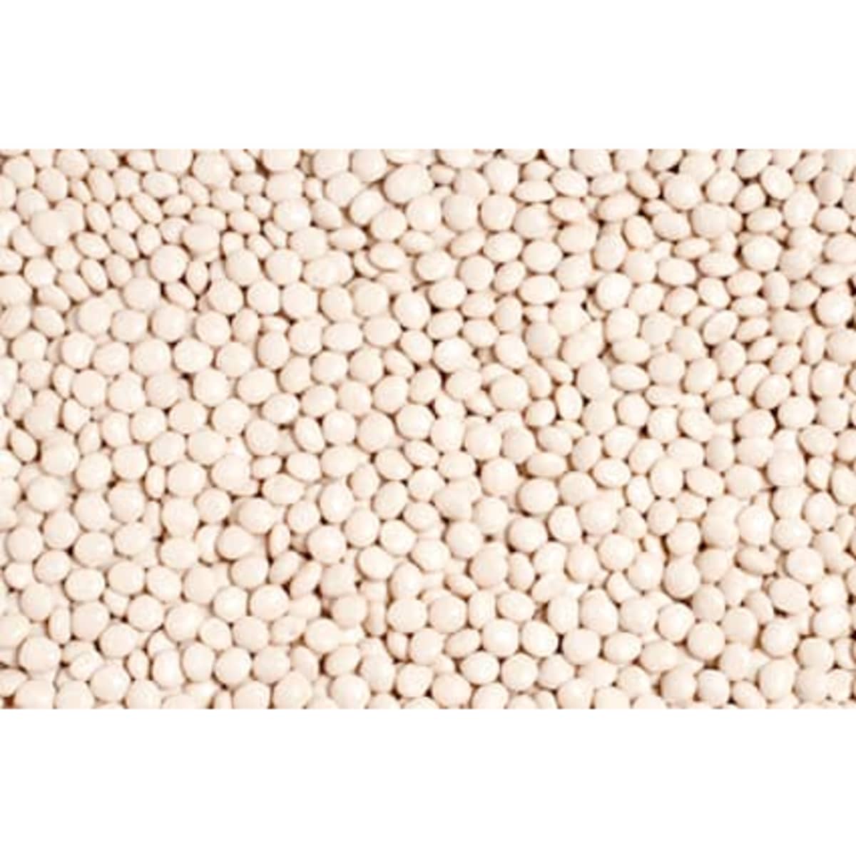 A pile of small, round, white mints arranged closely together, featuring a smooth surface.