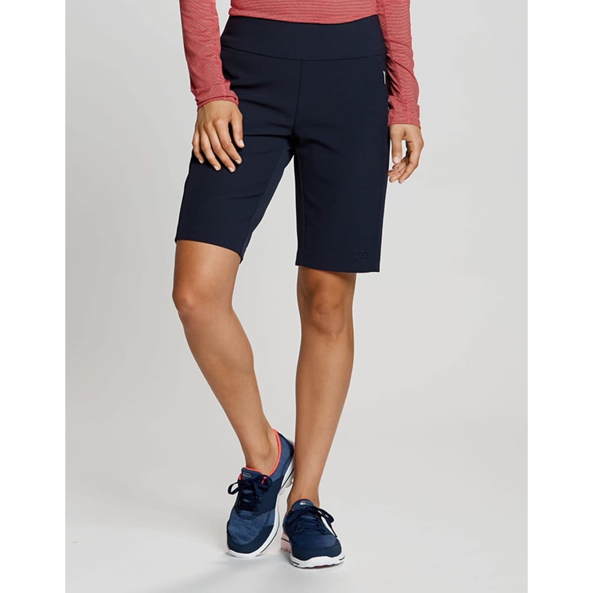 A pair of navy dress shorts with a fitted design, featuring a logo and styled for active wear.