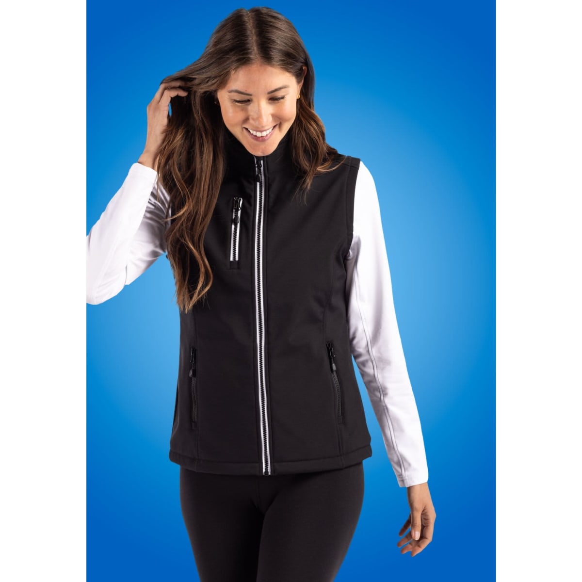 A black softshell vest featuring a zip front and side pockets, worn over a long-sleeved top.