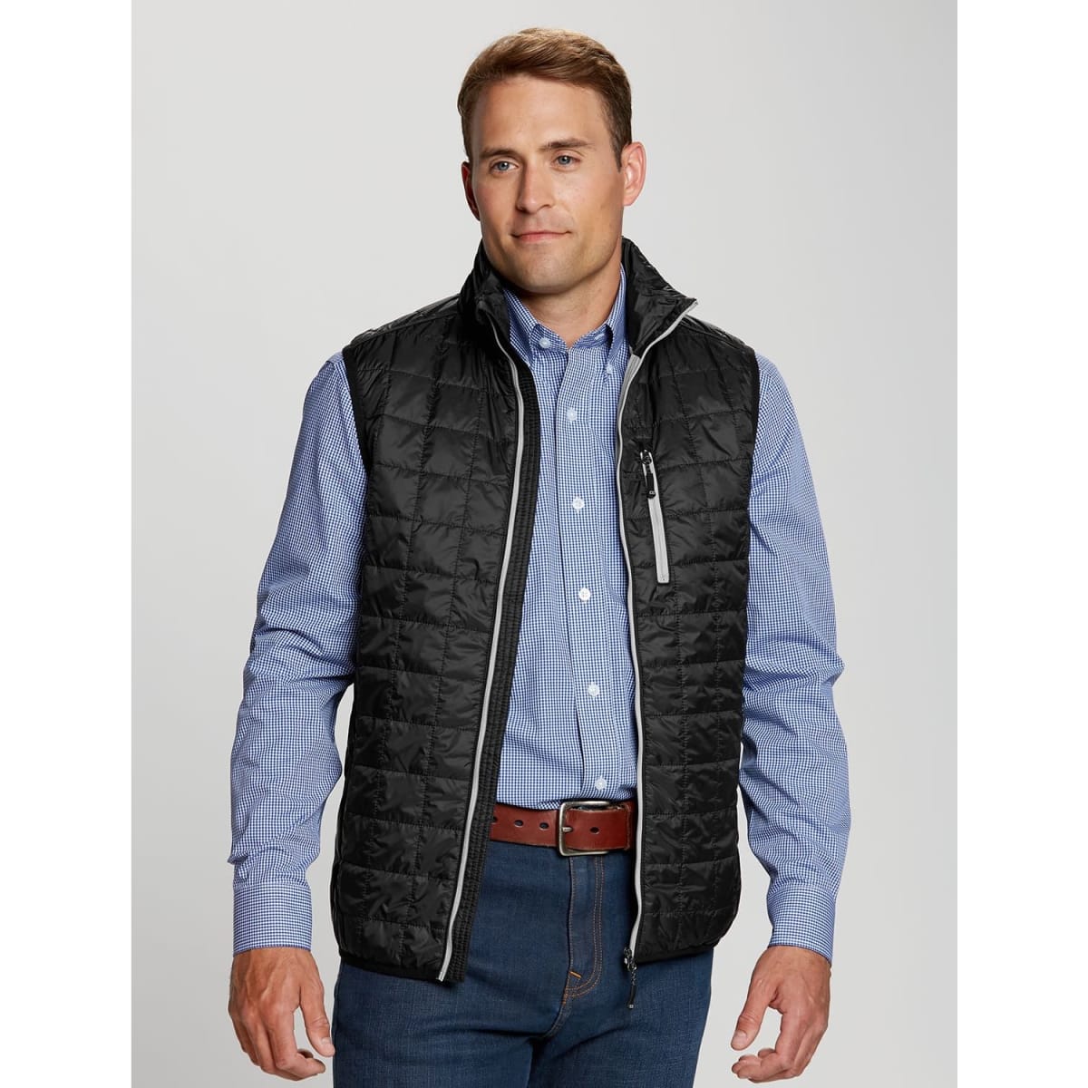 A black puffy vest with a high collar, worn over a blue checkered shirt, featuring a zippered pocket and grey accents.