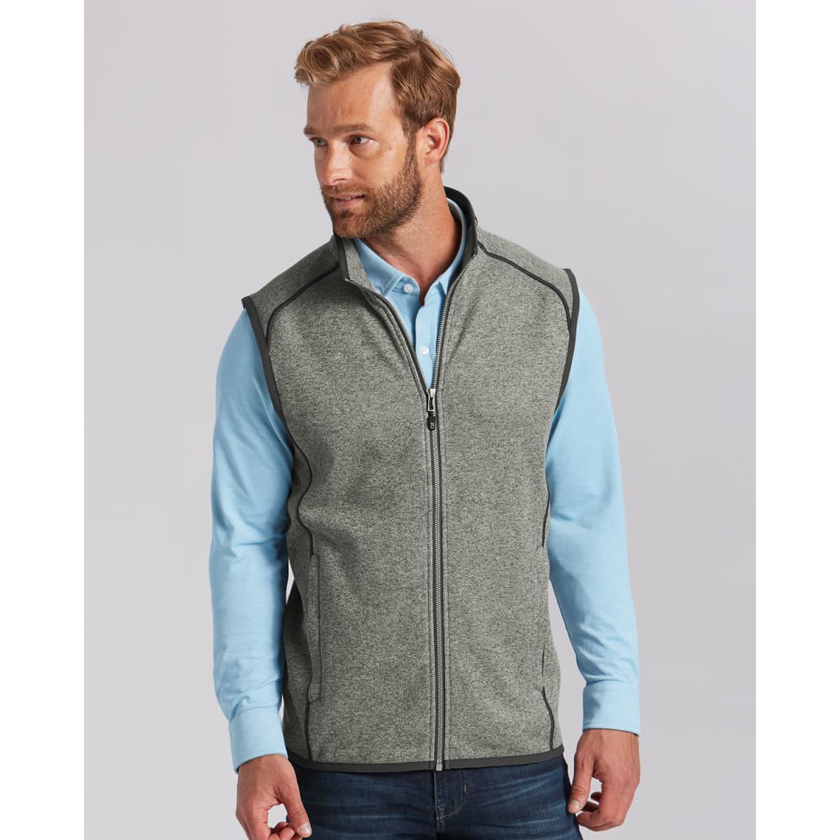 A grey men's vest with a zip front, featuring a high collar and contrasting trim, worn over a light blue shirt.