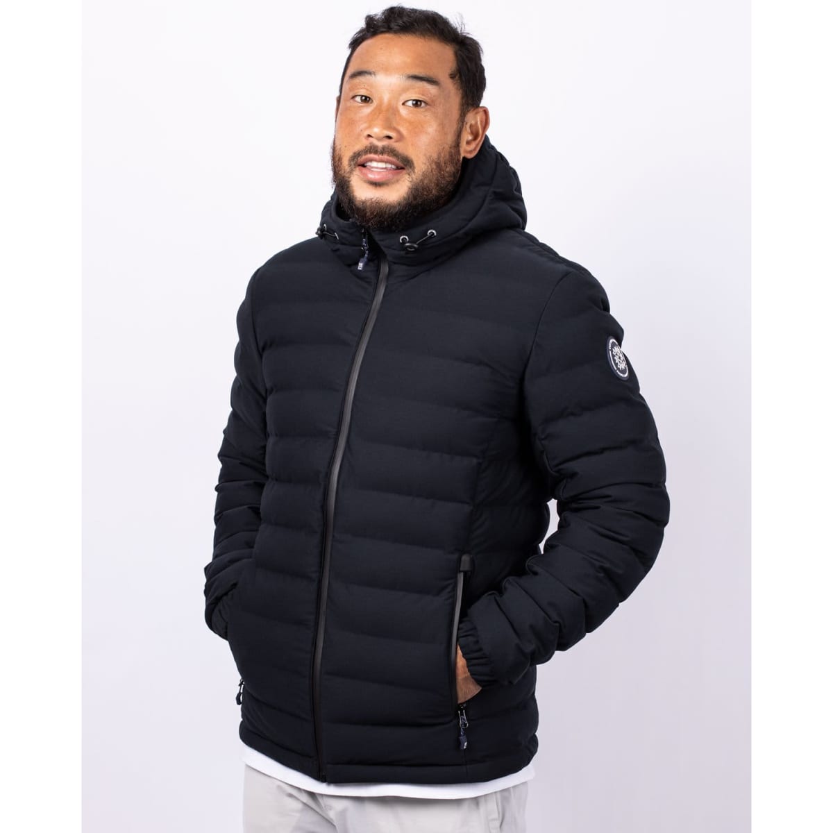 A black men's puffer jacket with a hood, featuring a logo and zippered pockets.