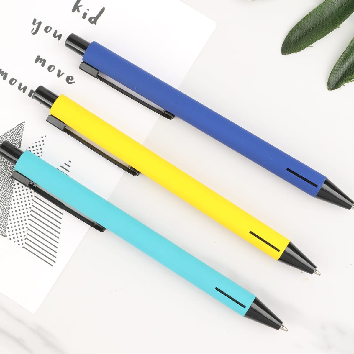 Three metal pens displayed in turquoise, yellow, and blue colours, featuring a sleek design and a clip.