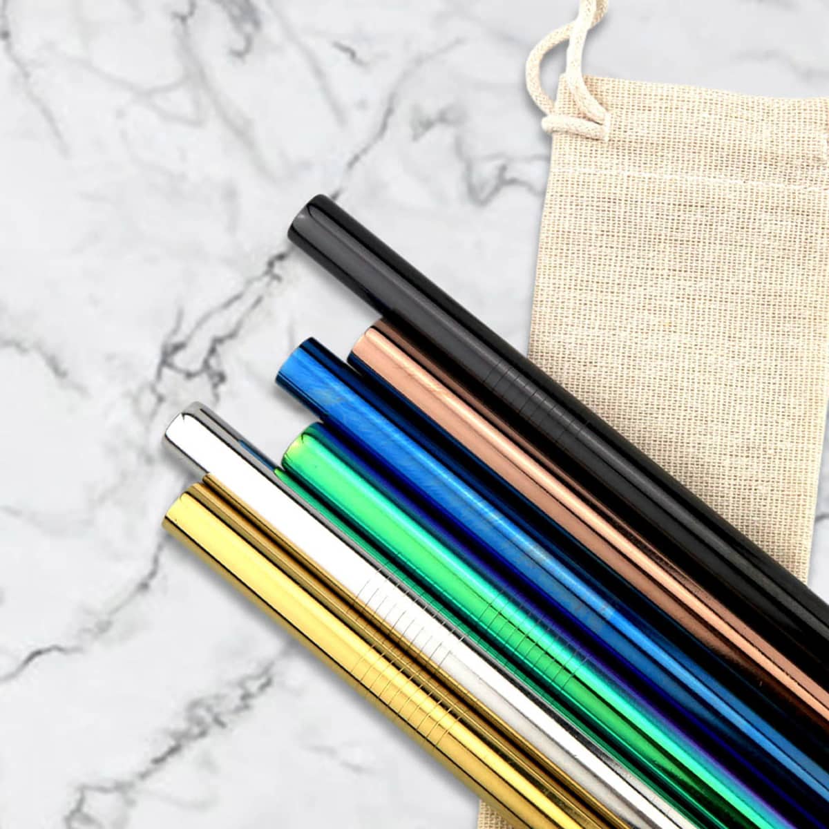 A set of stainless steel drinking straws in various colours, resting next to a fabric storage pouch.