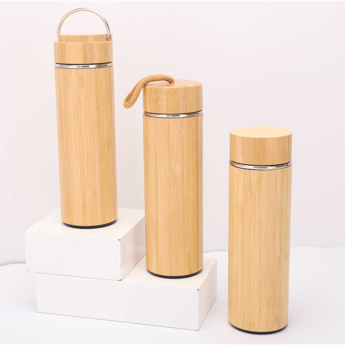 A drink bottle set featuring three bamboo-themed designs in various sizes, with a metallic finish and a logo.