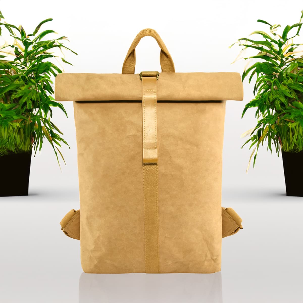 A kraft paper backpack in tan, featuring a roll-top design and a logo, set against a backdrop of potted plants.