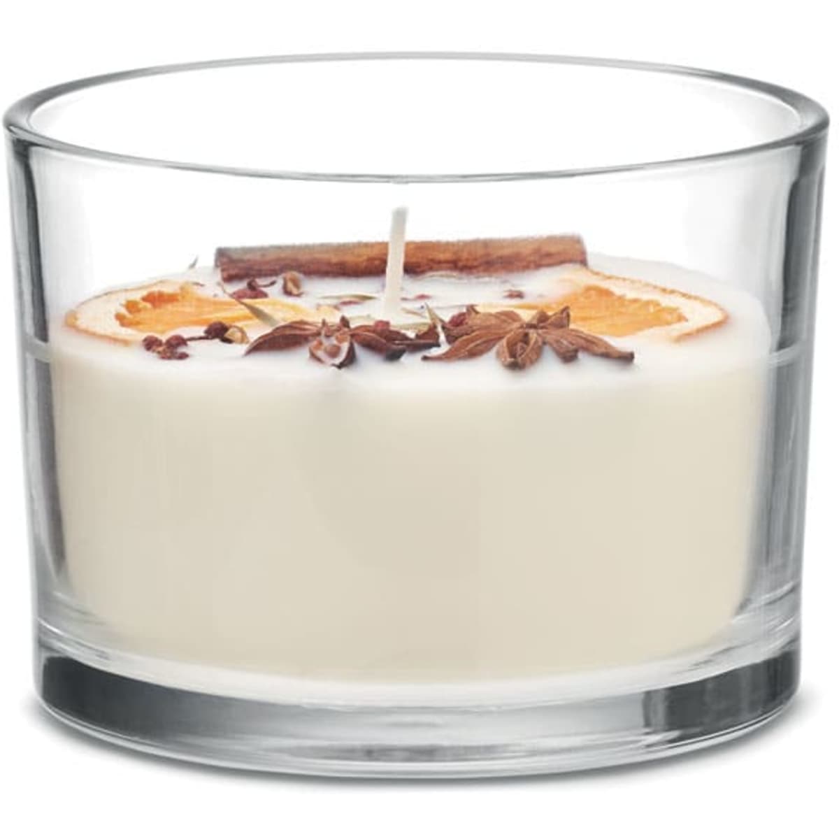 A candle in a glass holder, featuring a cream-coloured wax, dried orange slices, and spices on top.