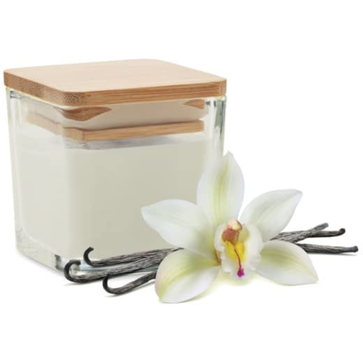 A glass candle jar with a wooden lid, filled with white wax, beside a vanilla flower and pods.