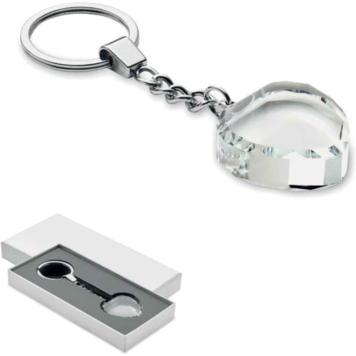 A keychain featuring a heart-shaped crystal charm, displayed in a white box. The charm is clear with faceted edges.