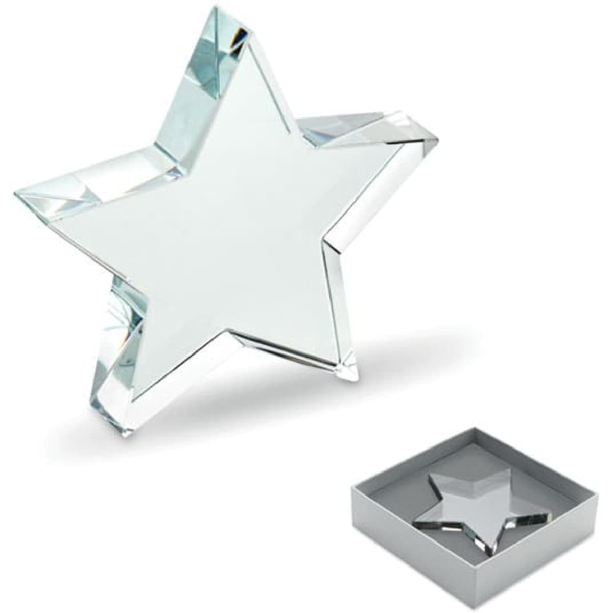 A star-shaped crystal paperweight in a silver box, reflecting light with a clear finish.