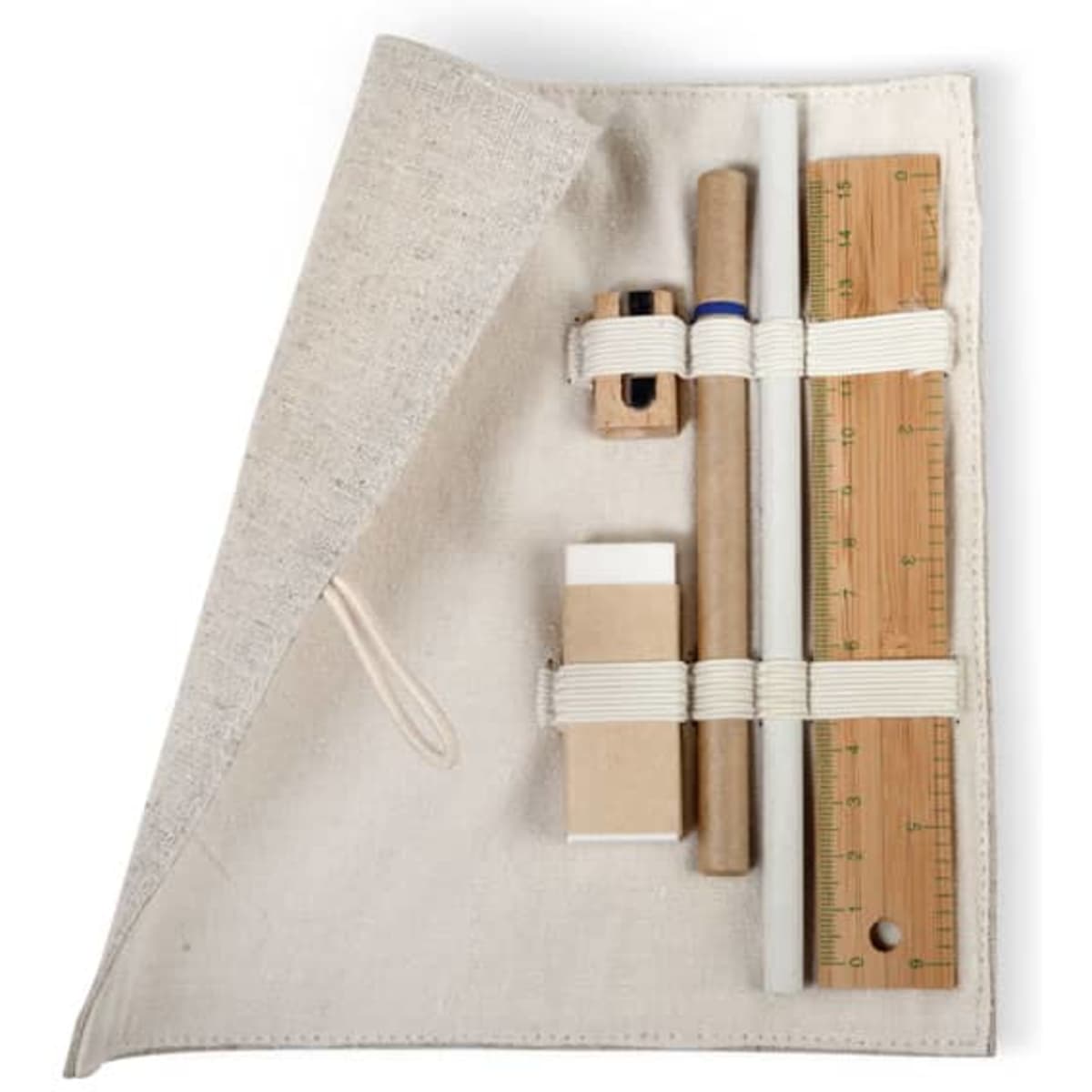 A canvas pouch in natural tones containing a ruler, pencil, sharpener, eraser, and piece of cardboard.