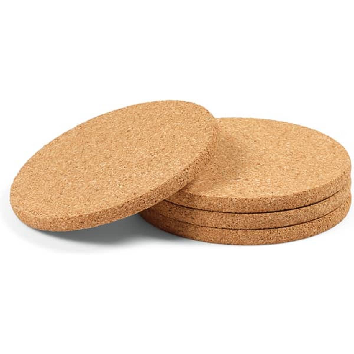 A set of four round cork coasters stacked together, featuring a natural beige colour and a smooth texture.