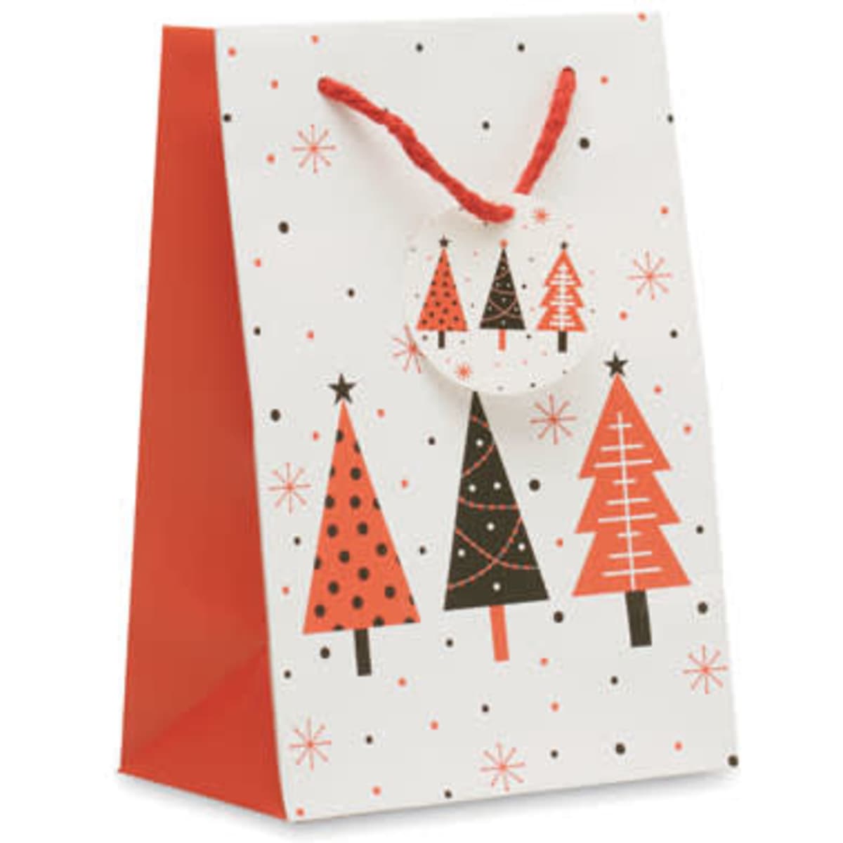 A decorative gift bag in white with red and black Christmas tree designs and a red cord handle.