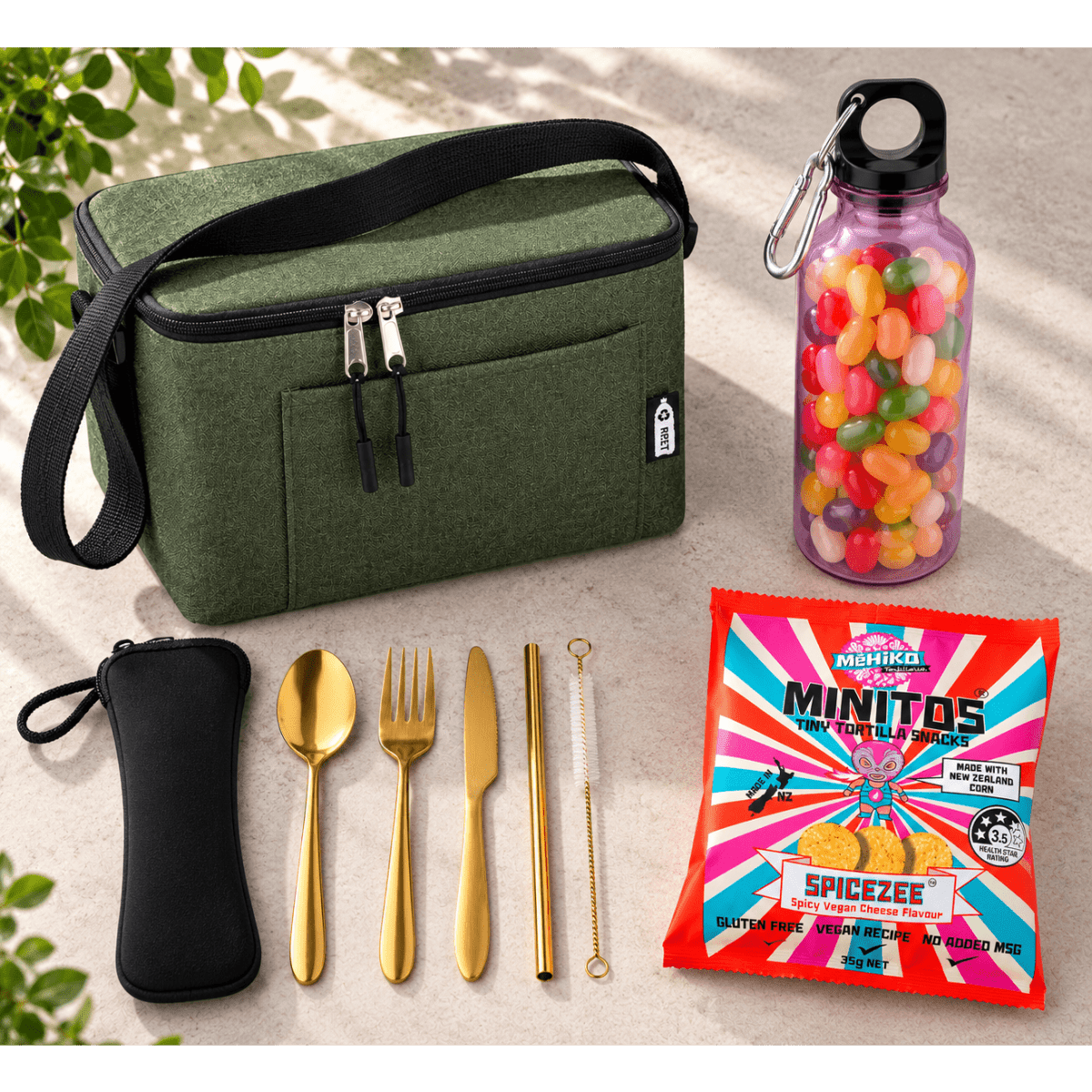 A green lunch bag, gold cutlery set, a drink bottle with colourful beads, and a snack packet.