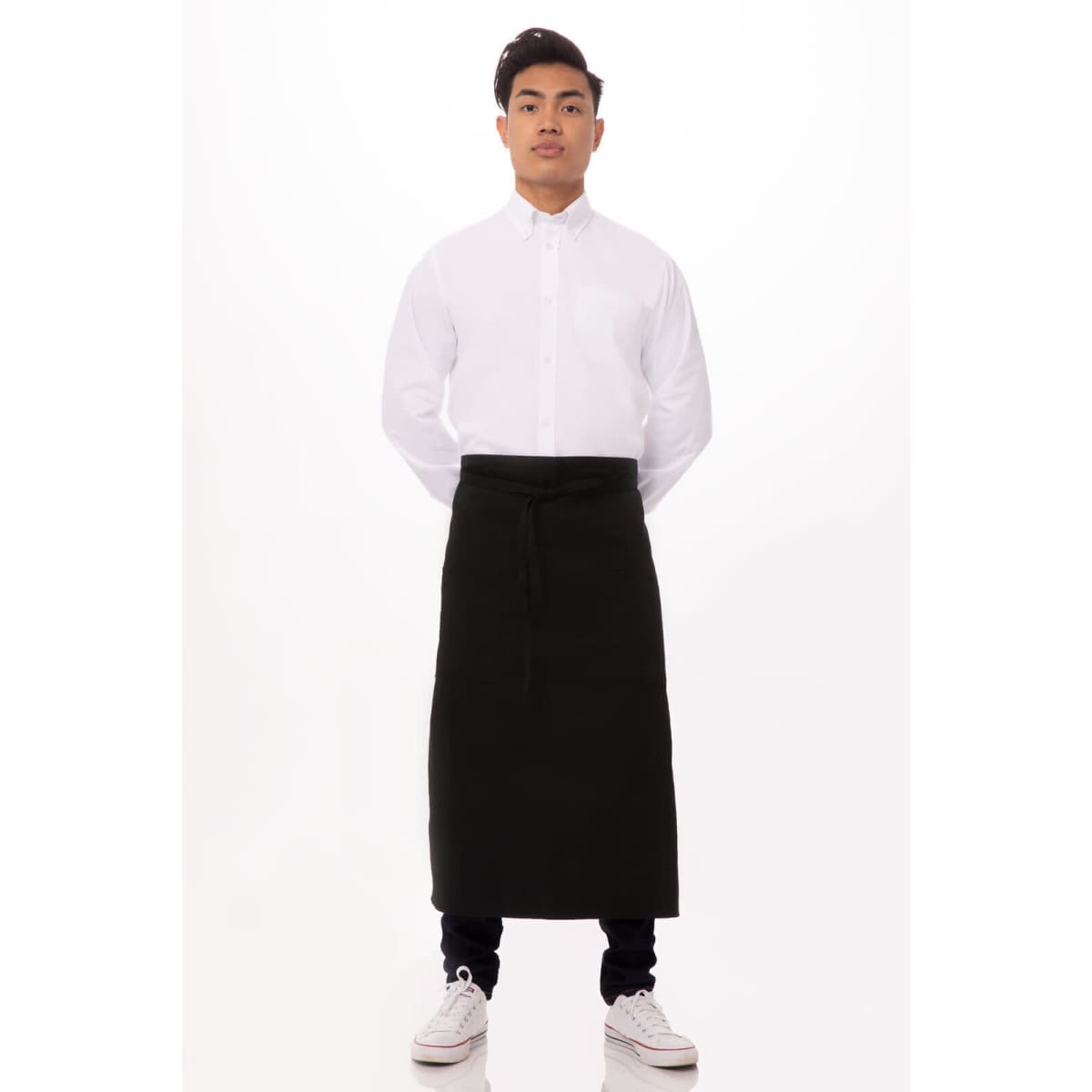 A black bistro apron worn over a white shirt, displayed on a model against a plain background.