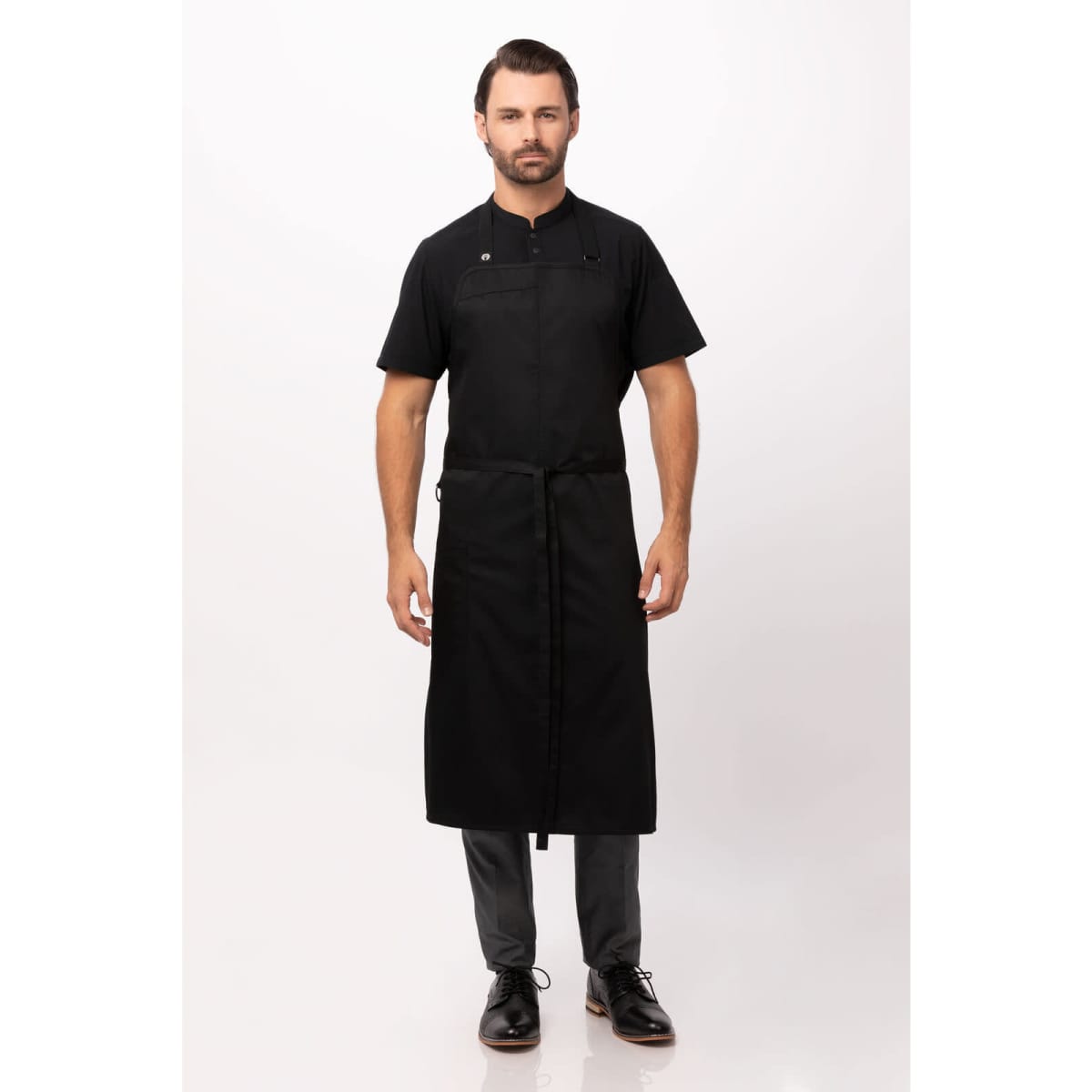 A black chef bib apron worn by a model, featuring a sleek design and a logo.