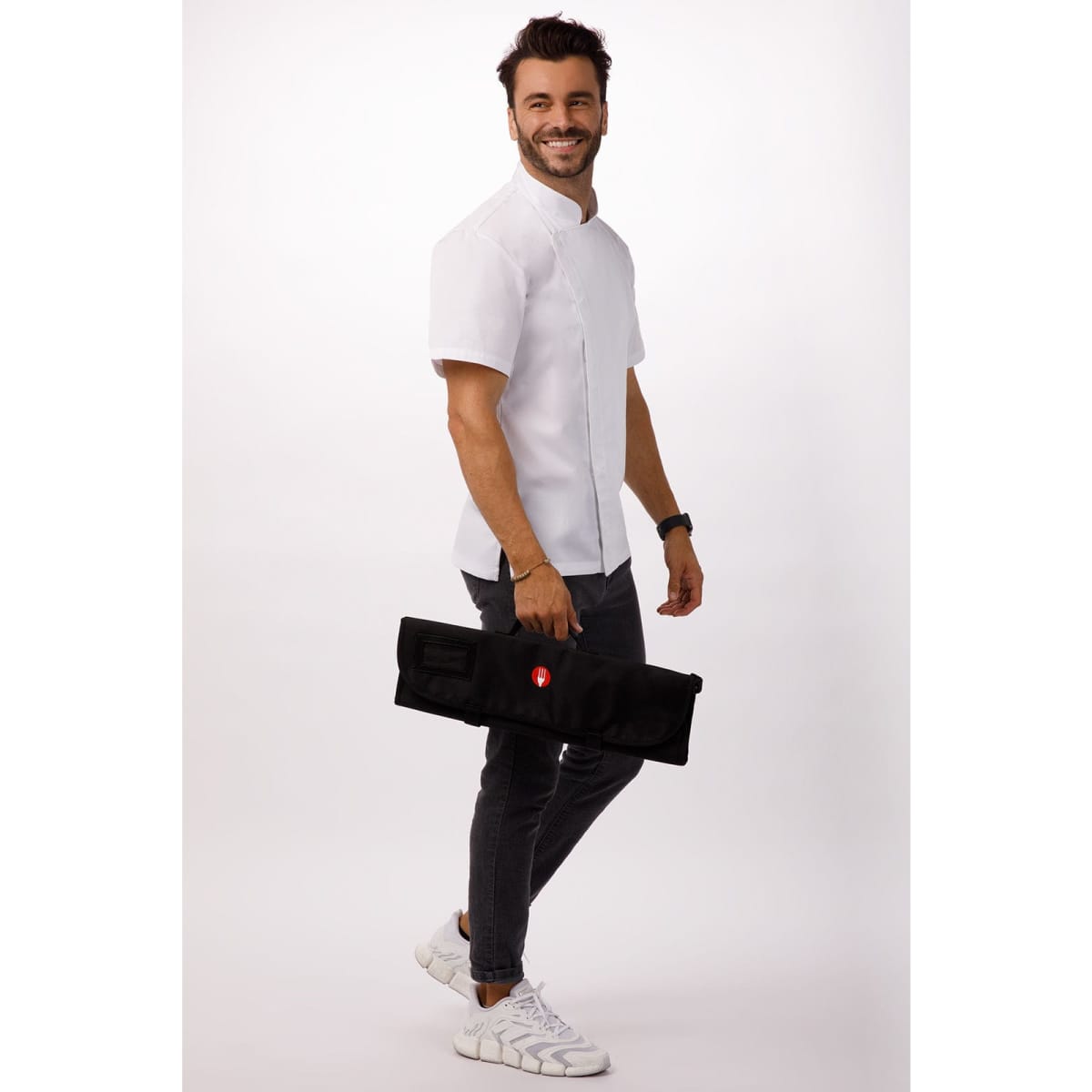 A man in a white shirt holds a black knife wrap bag featuring multiple pockets. The bag has a logo.