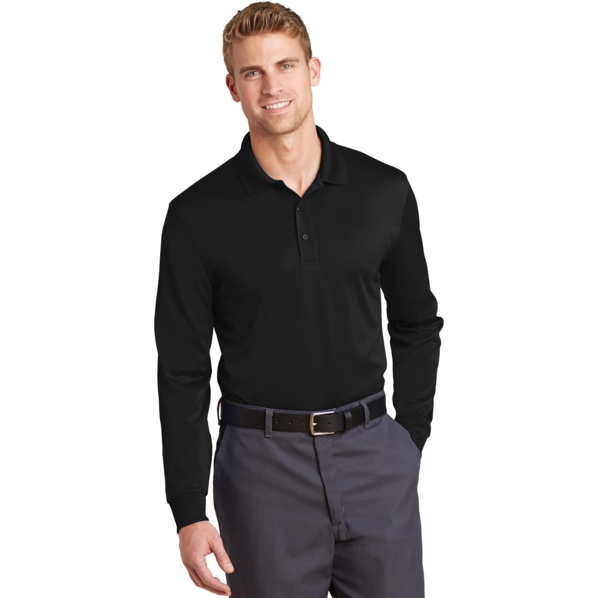 A man wearing a black, long sleeve polo shirt with a collar, paired with grey trousers. The shirt has a logo on it.