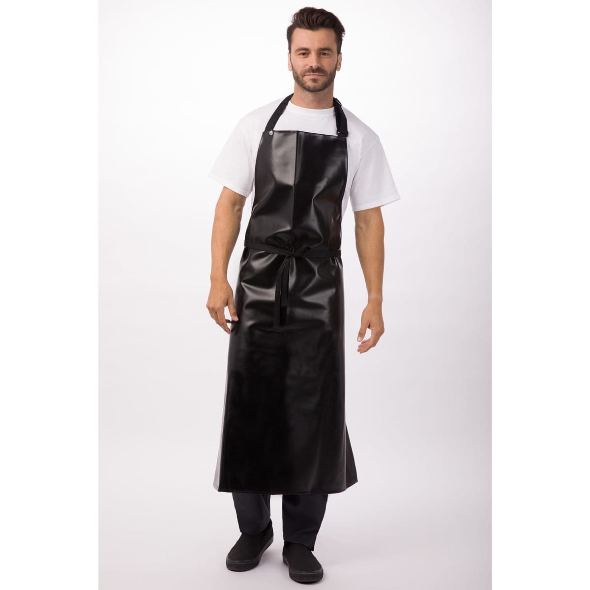 A black PVC bib apron is worn by a man standing against a plain background. The apron features a tie at the waist and shoulder straps.