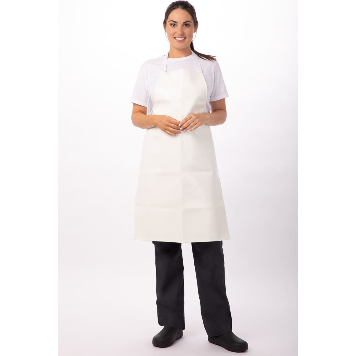 A woman wearing a short white PVC bib apron over a white shirt and black pants, standing against a plain background.