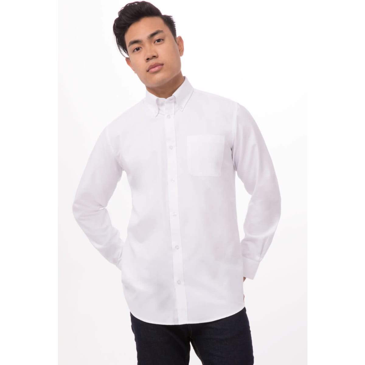 A white Oxford men's dress shirt with a button-up front, featuring a chest pocket, modelled by a man.