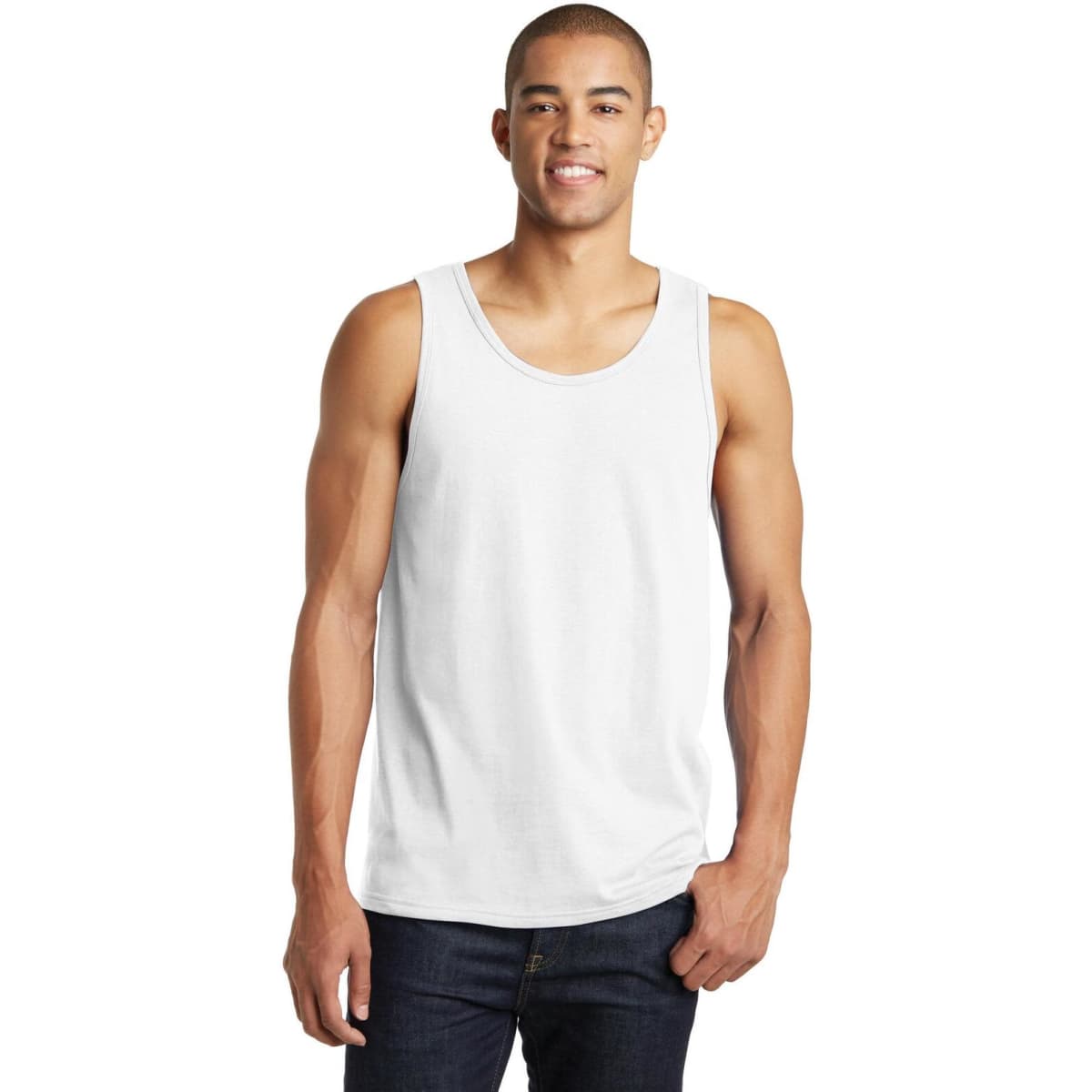 A young man wearing a plain white singlet tank top, standing with one hand in his pocket.