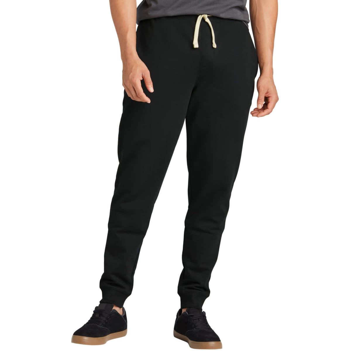 A black jogger with a drawstring, featuring a fitted design and ribbed cuffs. It includes a logo on the waistband.