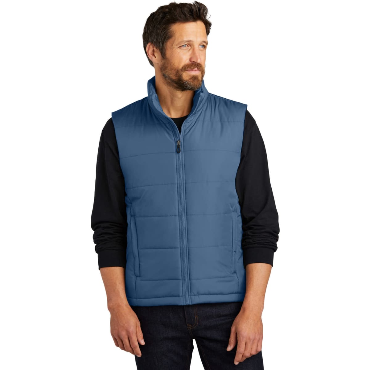A man wearing a blue puffer vest stands against a plain background. The vest features a zip closure and a branded logo.