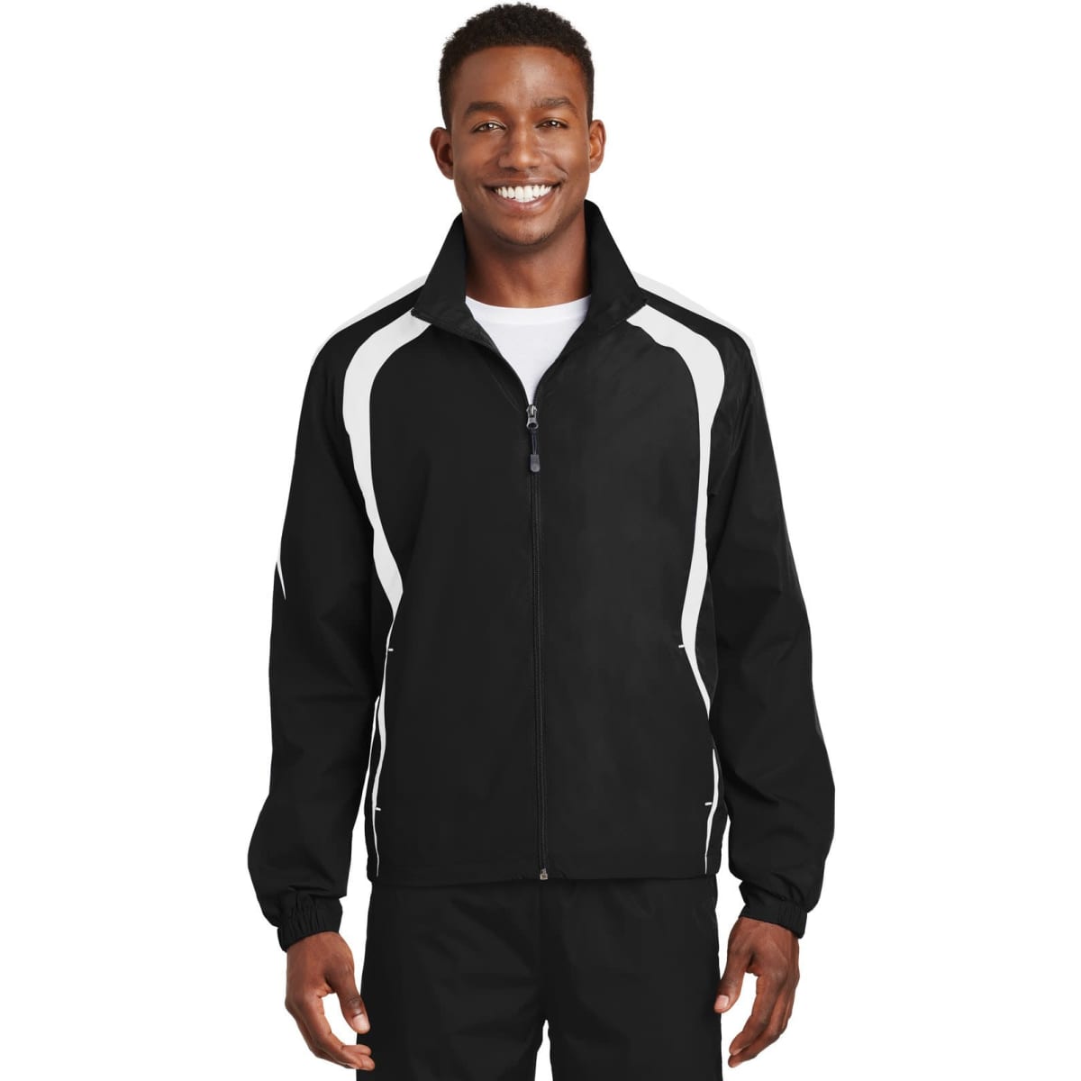 A jacket featuring a colourblock design in black with white accents, styled as a track jacket. It has a logo.
