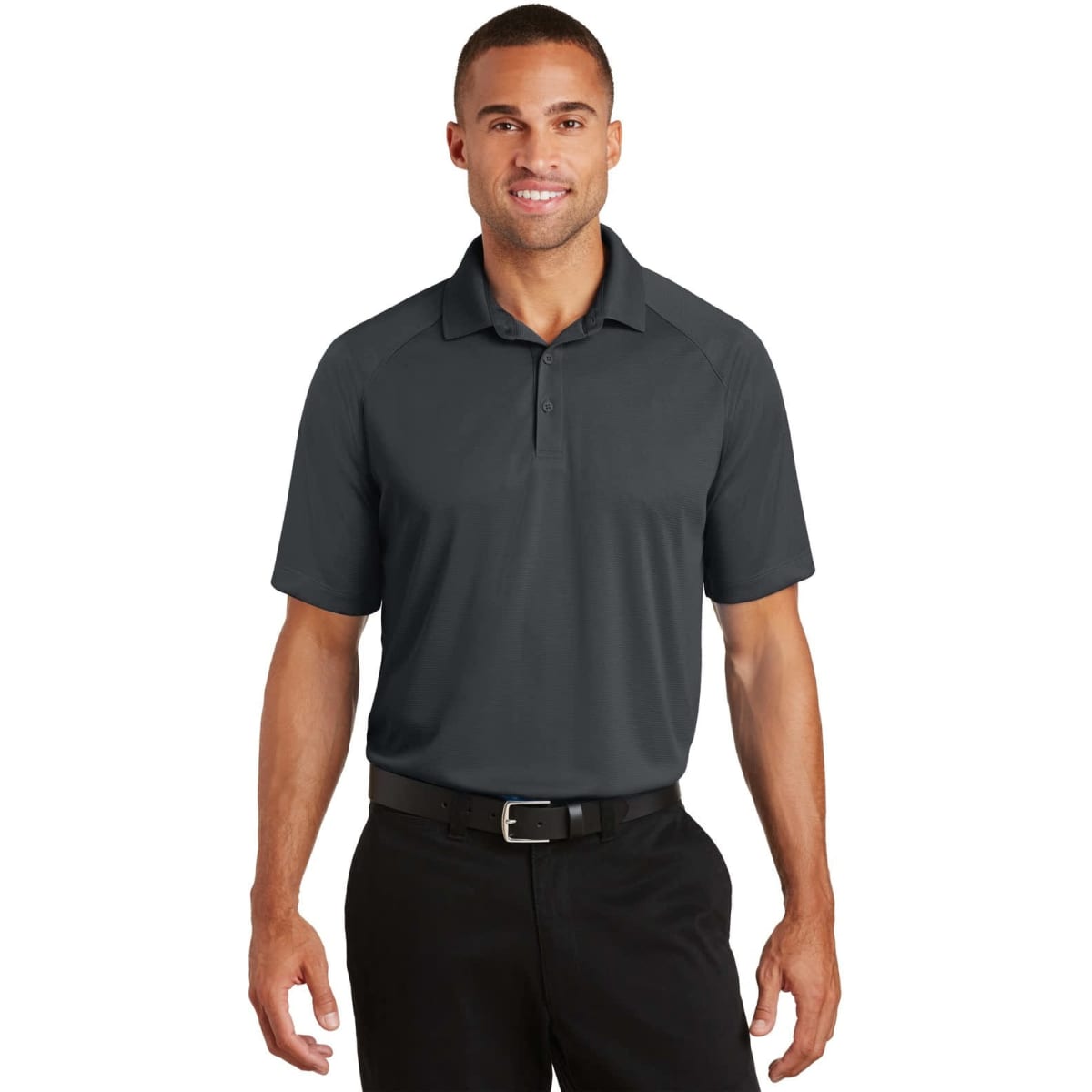 A dark grey Port Authority Crossover Raglan Polo shirt worn by a male model, featuring a logo on the chest.