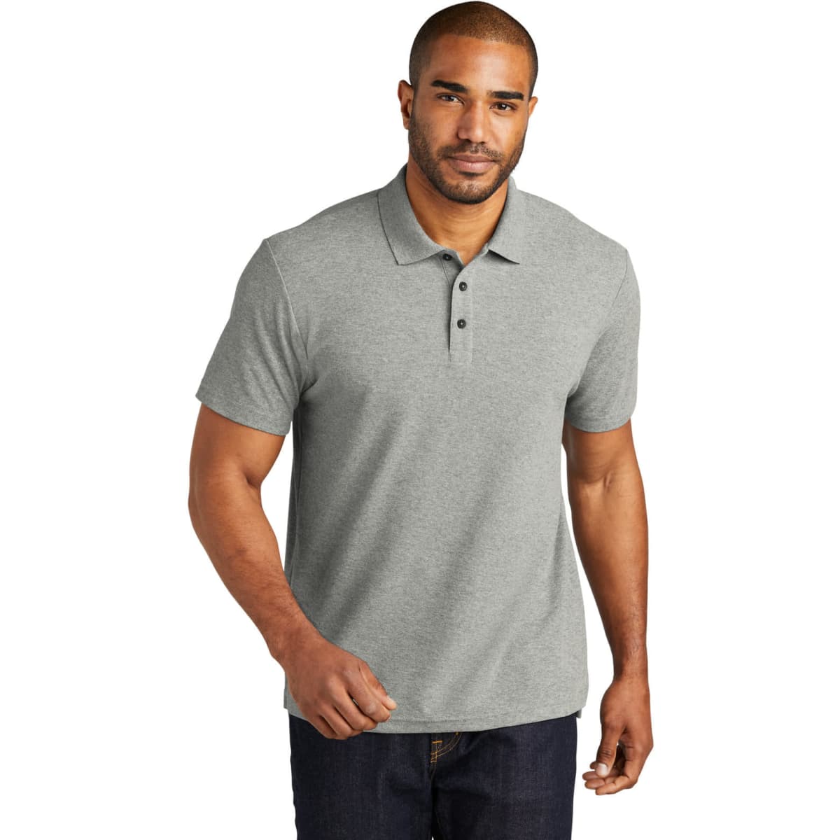 A grey polo shirt featuring a collar, buttons, and short sleeves, modelled by a man. It includes a logo.